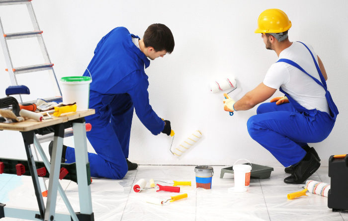 How do professionals paint interior walls?